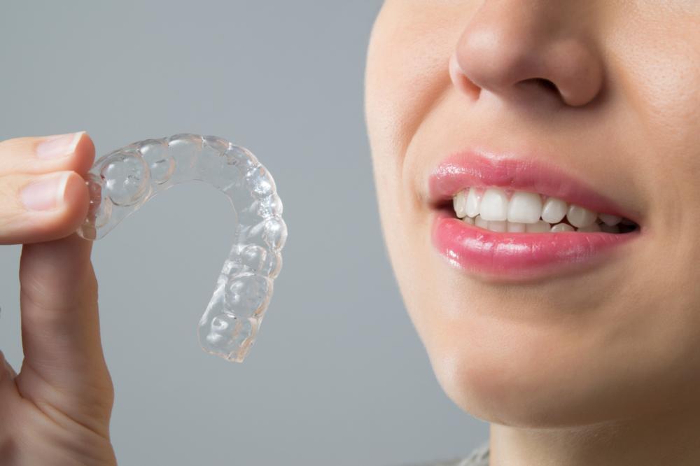 Lady holding clear aligners at CFS Dental
