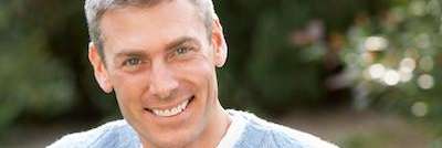 Patient smiling after getting dental implants from CFS Dental