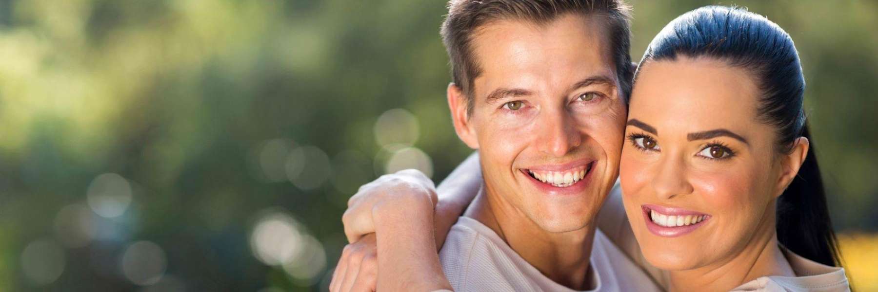A couple smiling after dental restoration in Oatly, NSW.