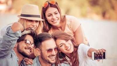 Friends taking a selfie after getting Invisalign clear aligners from CFS Dental